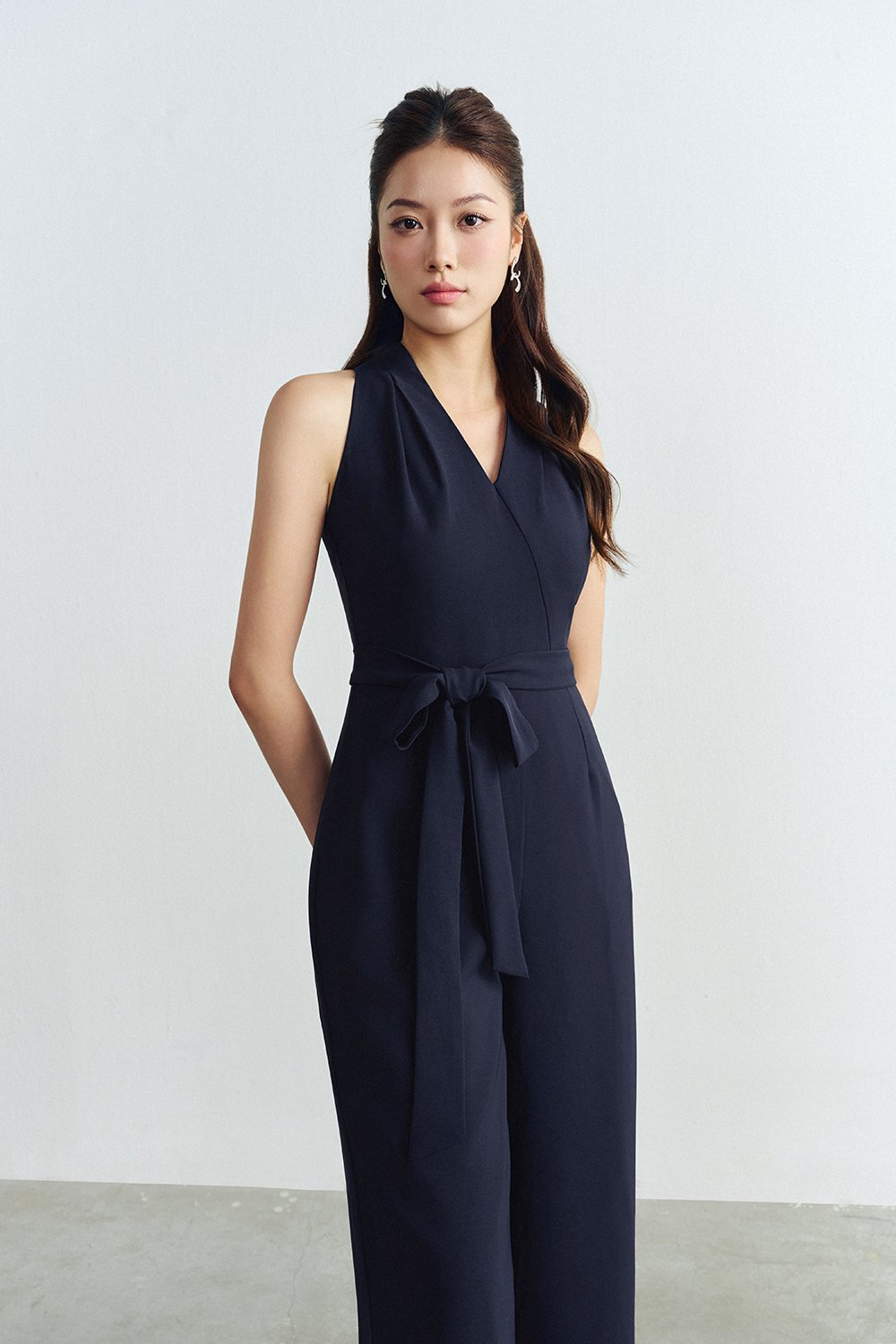 Juni Pleated V-Neck Jumpsuit with Sash Belt in Navy Blue