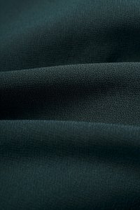 Rachel Padded Asymmetrical Wrap Top in Emerald Green