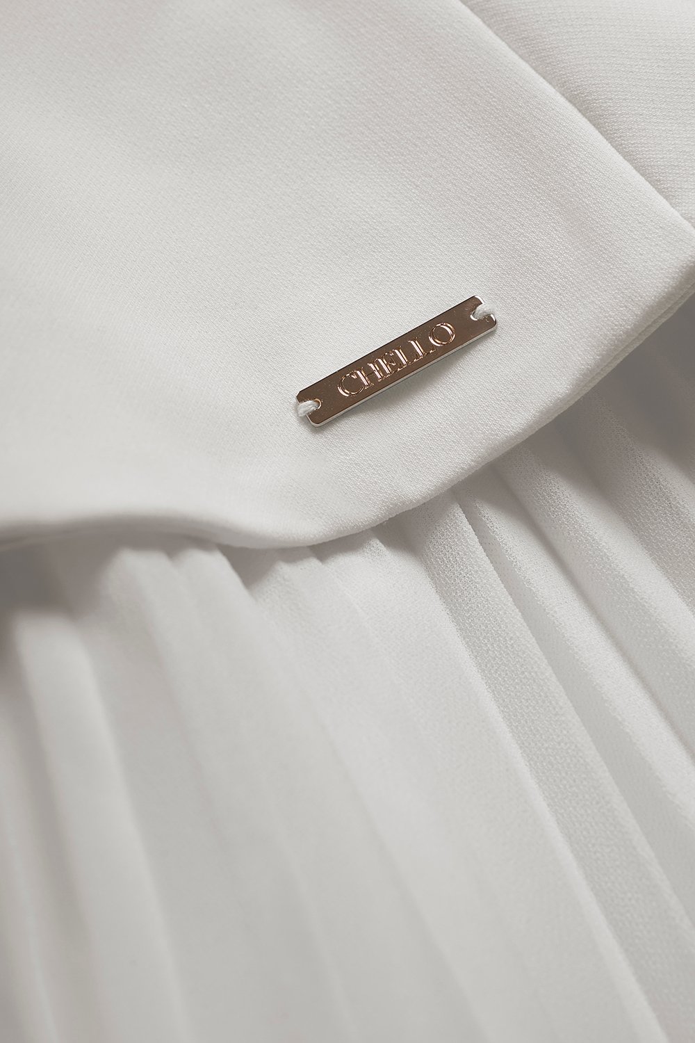 Cyrille Padded Peplum Pleated Dress in Iconic White
