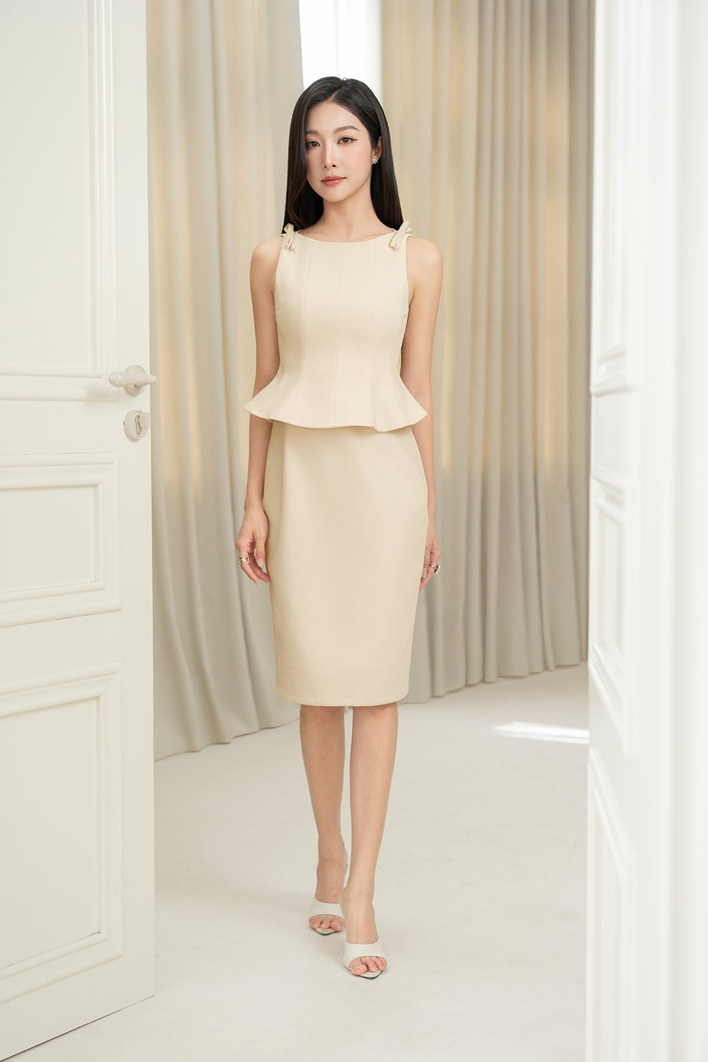 Darlene Padded Bow Peplum Pencil Dress in Cream